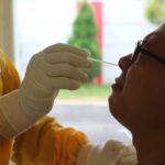 an employee is taking a swab test for COVID-19