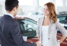 A picture of a car buyer learning about a vehicle protection plan from CarGuard Administration.