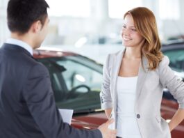 A picture of a car buyer learning about a vehicle protection plan from CarGuard Administration.