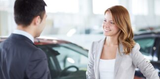 A picture of a car buyer learning about a vehicle protection plan from CarGuard Administration.