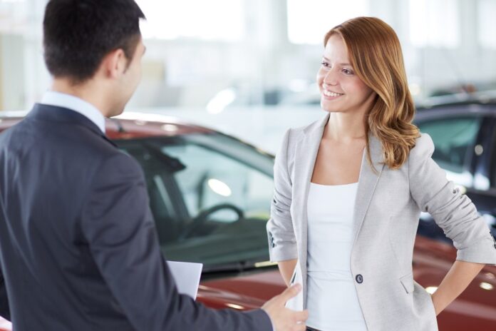 A picture of a car buyer learning about a vehicle protection plan from CarGuard Administration.